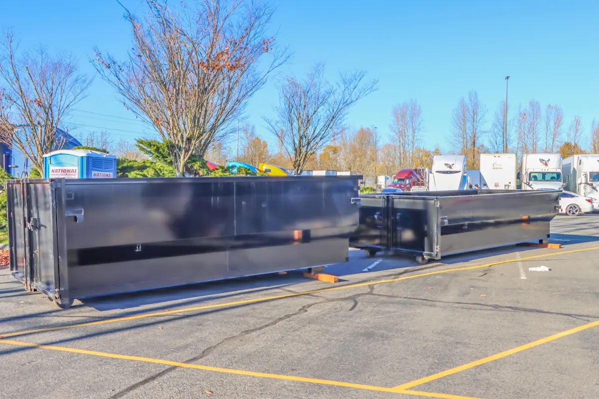Professional dumpster rental service with roll-off container on residential driveway in Kanab